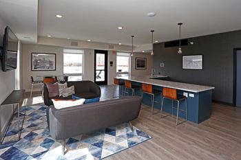 Penthouse Sky Lounge complete with an Entertainer's kitchen, comfortable seating, and a Flat Screen TV.